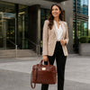 Business professional with Leather Business Laptop Bag, stylishly dressed in a blazer, standing outside an office building.