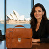 Leather Laptop Briefcase shown with a model near the Sydney Opera House.