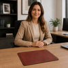 Leather Mouse Pad on a desk with a woman in a suit smiling at the camera, showcasing premium quality and elegance.
