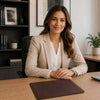 Professional woman sitting at a desk with a Leather Mouse Pad, showcasing elegance and premium office accessories.