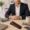 Leather Pen Pouch placed on a desk with pens, laptop, glasses, and a man in a suit demonstrating stylish office accessories.