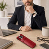 Leather Pen Pouch on a desk with a man in a suit, surrounded by a laptop, glasses, and a coffee cup.