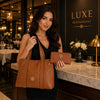 Leather Shoulder Bag and Zip Around Wallet Set displayed by a woman in an elegant restaurant setting.