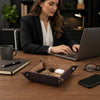 Large Leather Desk Tidy Tray holding keys and essentials on an office desk with a woman using a laptop.