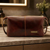 Mens Leather Wash Bag made from hand stained full grain leather on a countertop.