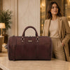 Stylish woman with the Leather Travel Duffel Bag in a luxurious setting, showcasing its elegant design and quality.