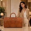 Leather Travel Duffel Bag displayed elegantly beside a woman in a stylish beige outfit, showcasing its modern design.
