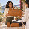 Leather Travel Gift Set featuring a duffle bag, toiletry bag, and passport cover displayed in a beautiful outdoor setting.
