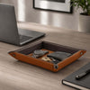 Leather Valet Tray with keys, watch, and wallet on a desk beside a laptop.