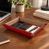 Leather Valet Tray in Lipstick Red holding keys, wallet, watch on a desk with laptop in a modern workspace