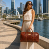 Woman holding a Weekender Travel Bag at a waterfront in perth city.
