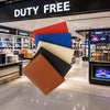 Leather Passport Wallets in various colors displayed in a duty-free store, showcasing premium travel accessories.