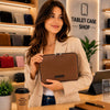 Woman holding a Luxury Soft Leather Tablet Case inside a tablet case shop.