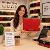 Woman holding a Luxury Soft Leather Tablet Case at a tech store, showcasing its premium design and features.