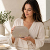 Luxury Soft Leather Toiletry Case held by a woman in a bathroom setting, showcasing its elegant design and practical use.