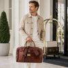 Man holding a Luxury Leather Travel Bag, showcasing its premium Italian leather and stylish design.
