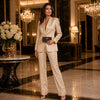 Elegant woman in a satin suit holding a Luxury Zip Around Leather Wallet, with a lavish lobby backdrop.