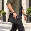 Man Waling And Holding The Black Mens Italian Leather Clutch Bag