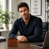 Mens Trifold Leather Wallet displayed on a desk with a man in a navy polo shirt, in an elegant office setting.