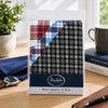 Mens Quality 10 Pack Handkerchiefs in stylish packaging with assorted designs showcased on a desk.