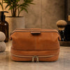 Mens Toiletry Bag Leather displayed with a smooth leather finish on a bathroom countertop.