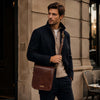 Stylish man wearing a Messenger Leather Shoulder Bag in modern urban setting, showcasing Mens Leather Shoulder Bag.