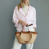 Woman Holding The Cognac Natural Raffia Shopping Bag