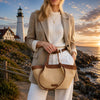 Leather Shopping Bag styled against a scenic lighthouse sunset backdrop.
