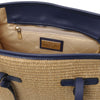 Inside view of Raffia Shoulder Bag showing spacious compartment, zip pocket, and pebbled leather accents.