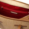 Interior of a Raffia Shoulder Bag featuring a zip pocket and spacious compartment.