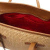 Interior view of the Raffia Shoulder Bag showcasing spacious compartment with red lining and organized pockets.