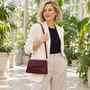 Shoulder Bag For Ladies worn by a woman in a stylish outfit surrounded by greenery in a bright setting.