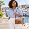 Shoulder Bag For Ladies worn by a woman in a blue shirt, enjoying a sunny day by the marina.