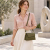 Elegant woman wearing a blouse and skirt, carrying a TL Bag Shoulder Bag For Ladies in olive green.