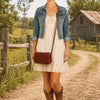 Woman wearing a denim jacket and dress, showcasing a stylish Shoulder Bag For Women outdoors.
