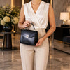 Small Leather Shoulder Bag held by a woman in elegant attire, showcasing sophisticated design and Italian elegance.