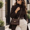 Beautiful woman in the street carrying the Chocolate Small Leather Shoulder  Bag as a Crossbody Bag
