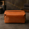 Small Leather Toiletry Bag made from premium Italian leather, featuring a zip top closure and a stylish design.