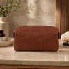Small Leather Toiletry Bag made from Premium Italian Leather on a marble countertop.