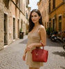 Woman Posing With The Red Small Leather Tote Handbag