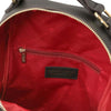 Inside view of Women’s Soft Leather Backpack showcasing red lining and zippered pocket.