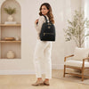 Woman wearing a Leather Women’s Soft Leather Backpack in a stylish indoor setting.