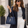 Woman In The Street Holding The Dark Blue Soft Leather Handbag 
