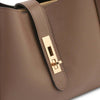 Soave Soft Leather Handbag In Dark Blue close-up of gold lock detail on luxurious pebbled leather exterior.