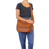 Woman Posing With The Cognac Tassel Crossbody Bag