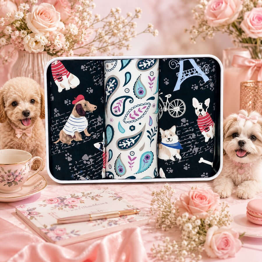 Dog-themed cotton handkerchief gift tin displayed with two dogs in a floral setting
