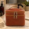 Travel Toiletry Bag made of full-grain vegetable tanned leather in a bathroom setting.