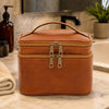 Travel Toiletry Bag in full-grain leather on bathroom countertop with grooming items organized inside.