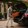 Man By His Car Boot With The Natural Travelling Bag