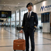 Pilot in uniform at Melbourne Airport with a Leather pilot case with wheels.